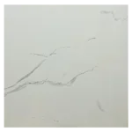 A minimalist white surface with subtle gray veining, resembling marble. The veins run diagonally across the image, adding texture and a natural pattern to the otherwise smooth, plain background. Its Called Glossy Polished Porcelain Carrara White Tiles